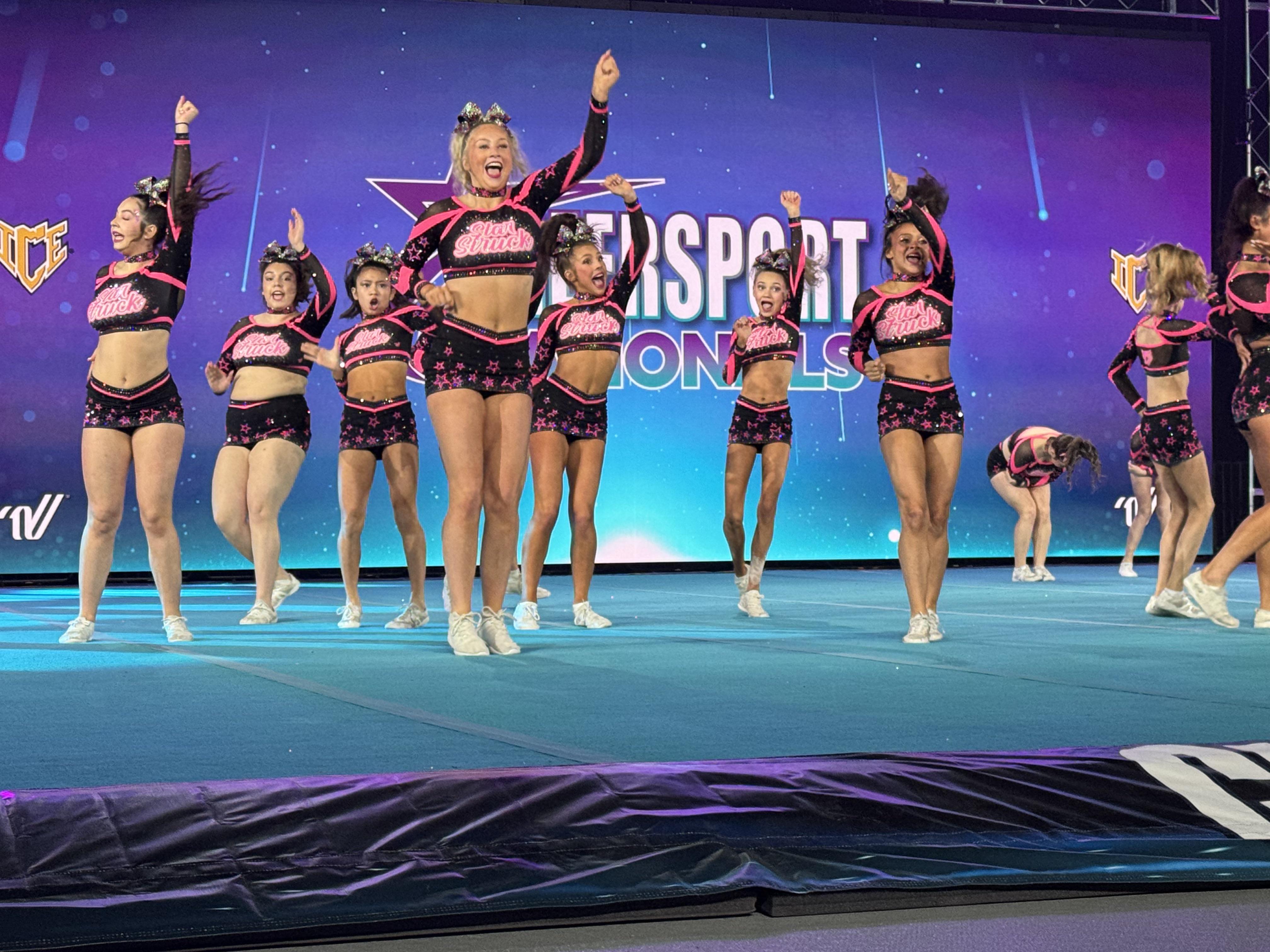 Ashlyn and her team celebrating on stage at Intersport Nationals